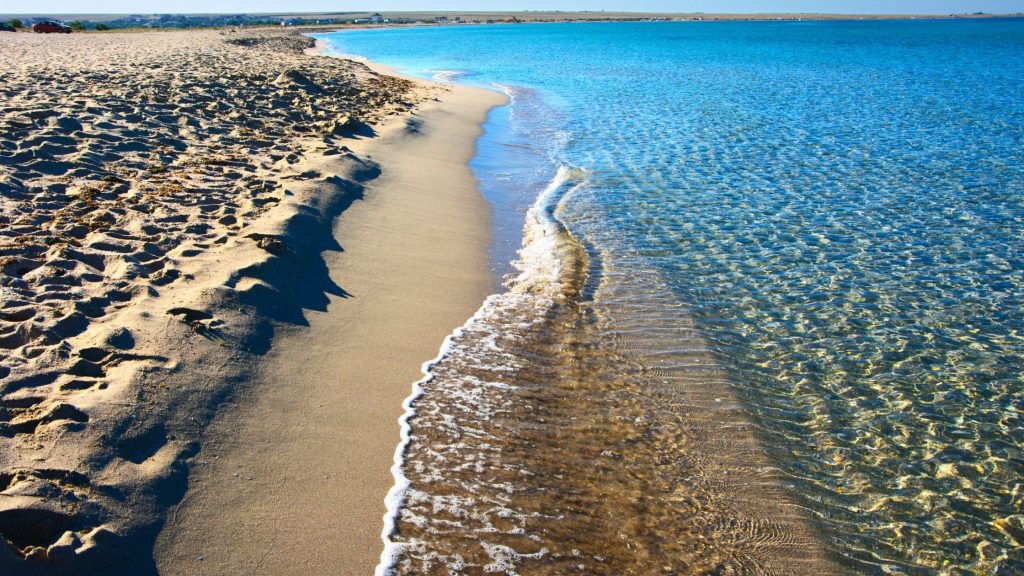 blue water waves and sand at Sunny Sands beach