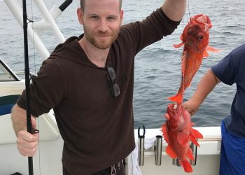 Jordan Warkol with a lobster in his hand