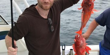 Jordan Warkol with a lobster in his hand