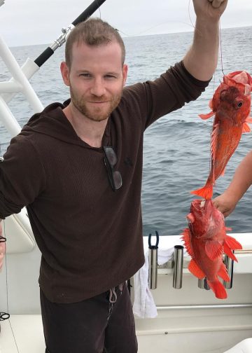 Jordan Warkol with a lobster in his hand