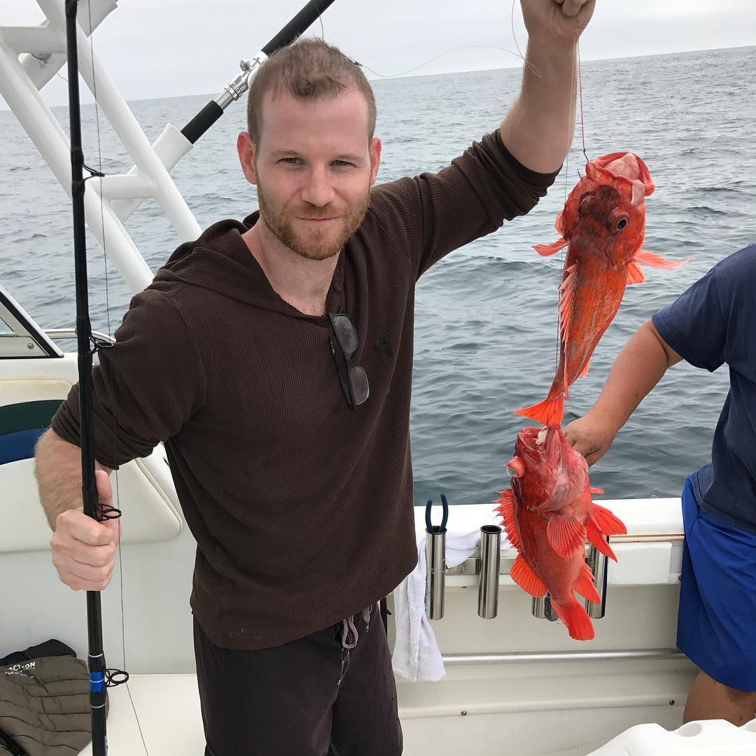 Jordan Warkol with a fish in his hand